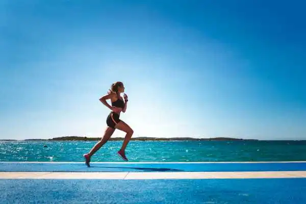Woman running showing strong leg muscle Selston